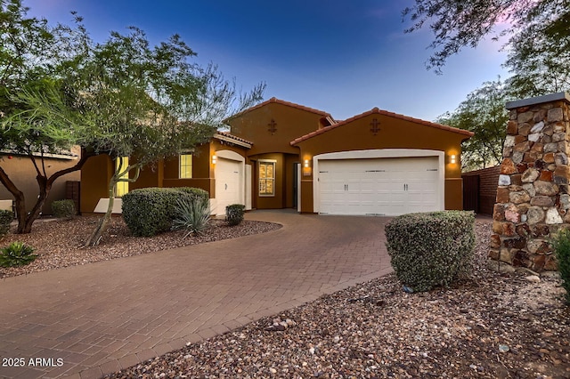 13145 W Whisper Rock Trl, Peoria, AZ 85383 - mediterranean / spanish house with an attached garage, decorative driveway, and stucco siding