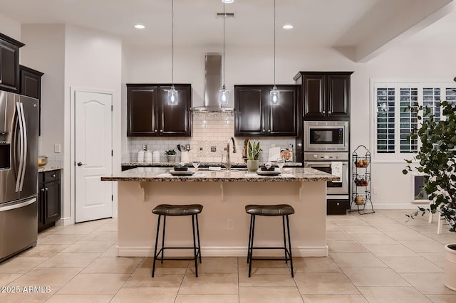 13145 W Whisper Rock Trl, Peoria, AZ 85383 - kitchen with stainless steel appliances, wall chimney exhaust hood, tasteful backsplash, light stone counters, and recessed lighting