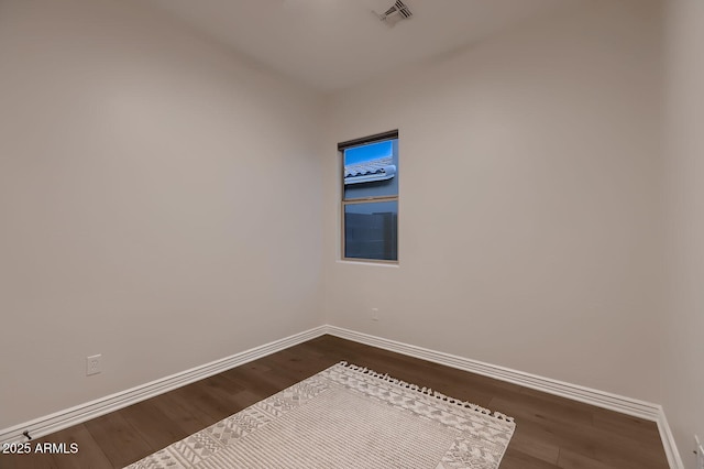 13145 W Whisper Rock Trl, Peoria, AZ 85383 - spare room featuring dark wood-type flooring and baseboards
