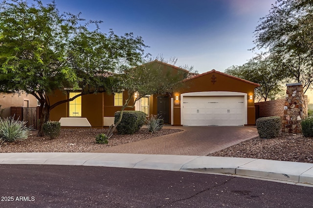 13145 W Whisper Rock Trl, Peoria, AZ 85383 - view of front facade featuring decorative driveway, an attached garage, and stucco siding