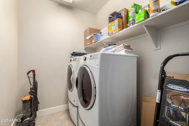 laundry room featuring light tile patterned floors and washing machine and dryer