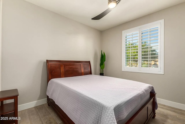 bedroom with light hardwood / wood-style flooring and ceiling fan