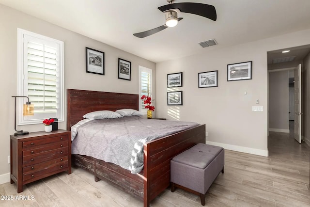 bedroom with multiple windows, ceiling fan, and light hardwood / wood-style floors