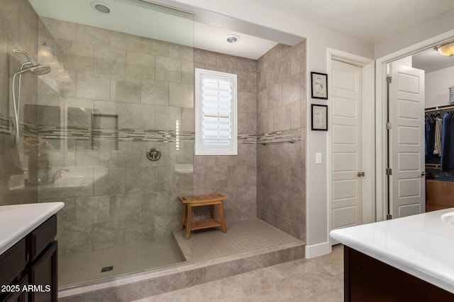 bathroom featuring vanity and a tile shower