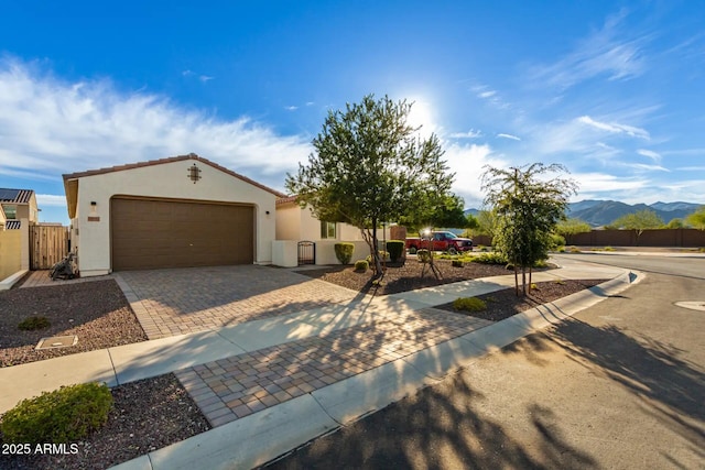 view of front facade featuring a garage and a mountain view