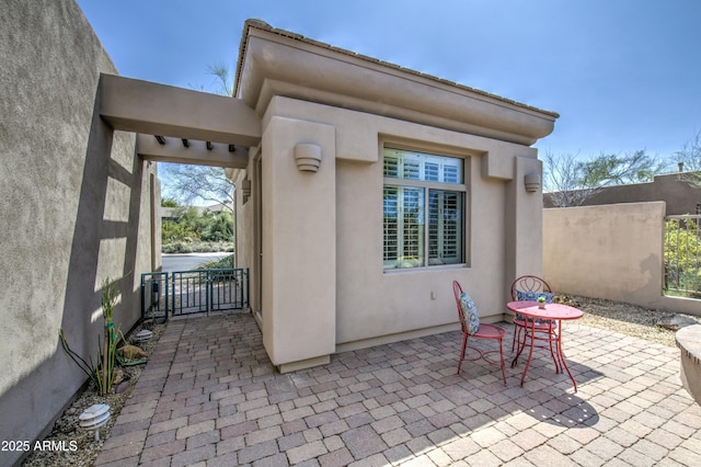 view of patio / terrace featuring a gate and fence