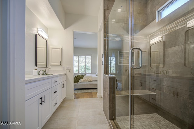 ensuite bathroom with a shower stall, ensuite bath, tile patterned flooring, and vanity