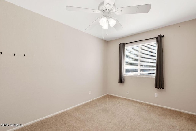 empty room with baseboards, ceiling fan, and light carpet
