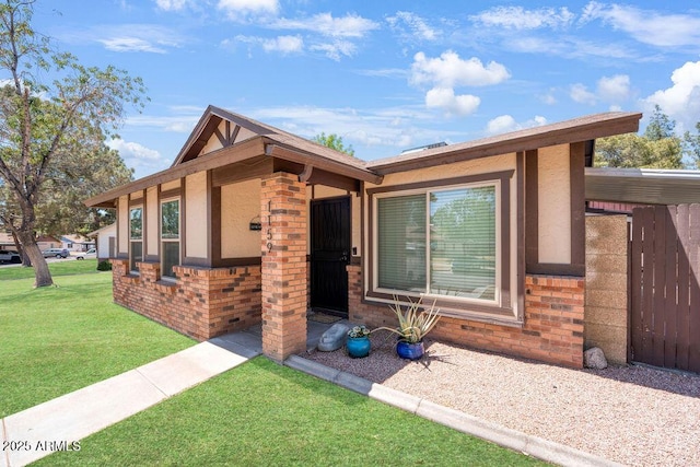 single story home with brick siding and a front lawn
