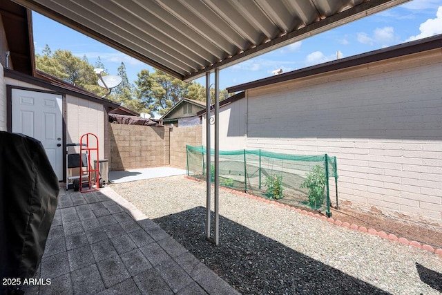 view of patio featuring a fenced backyard and an outdoor structure