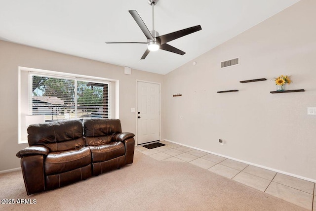 living room featuring visible vents, light tile patterned flooring, ceiling fan, light colored carpet, and vaulted ceiling