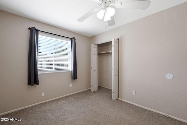 unfurnished bedroom featuring baseboards, carpet, and a closet