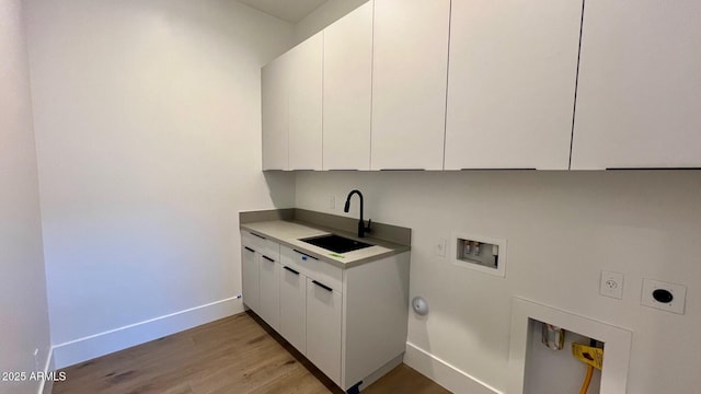 washroom featuring sink, cabinets, hookup for a washing machine, electric dryer hookup, and hookup for a gas dryer