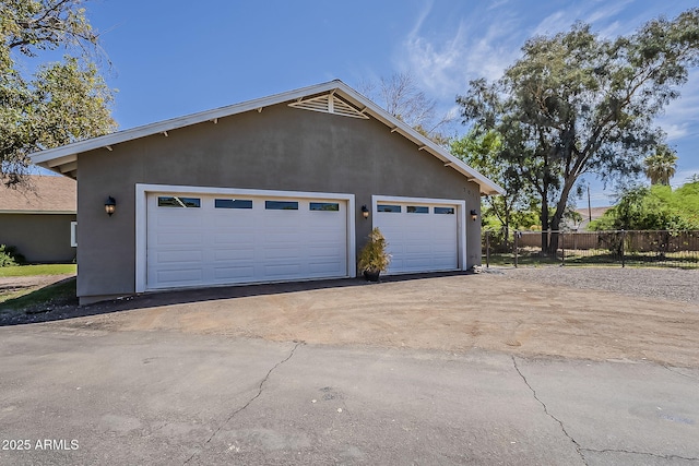 detached garage featuring fence