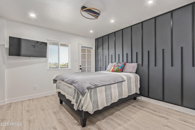 bedroom with recessed lighting, light wood-style flooring, and baseboards