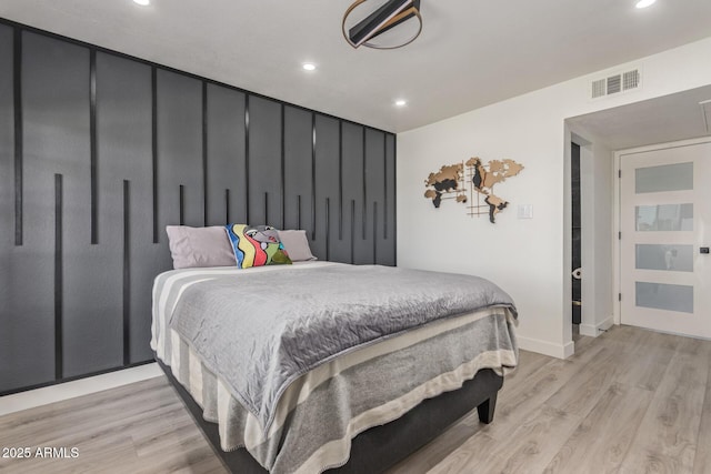 bedroom with recessed lighting, light wood-style floors, and baseboards