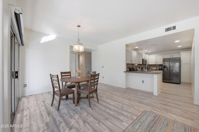 dining space featuring light hardwood / wood-style flooring