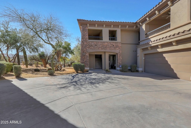 view of front of property with a garage and a balcony