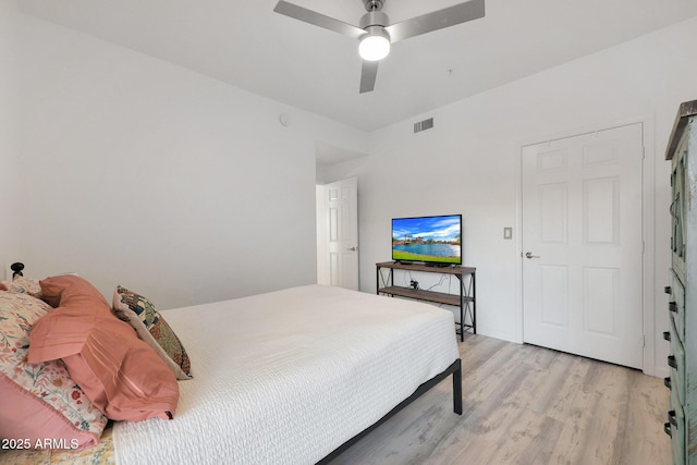 bedroom with light hardwood / wood-style floors and ceiling fan