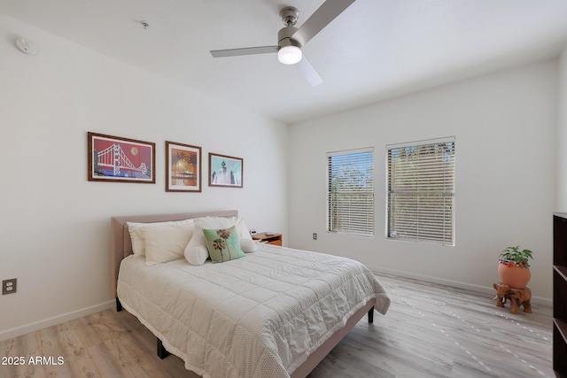 bedroom with ceiling fan and light hardwood / wood-style floors