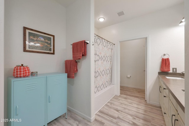 bathroom featuring vanity, hardwood / wood-style flooring, and shower / bath combo