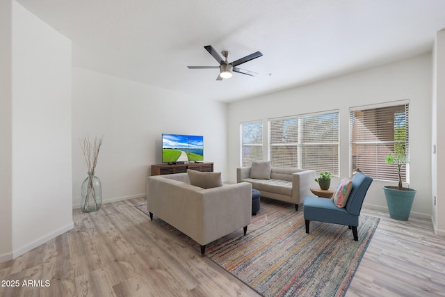 living room with ceiling fan and light wood-type flooring