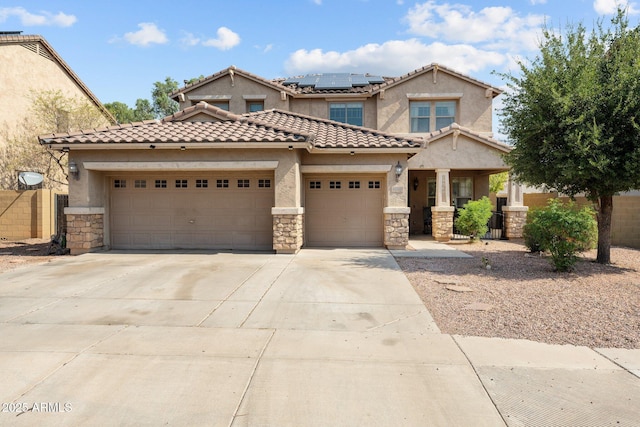 view of front of property featuring a garage and solar panels