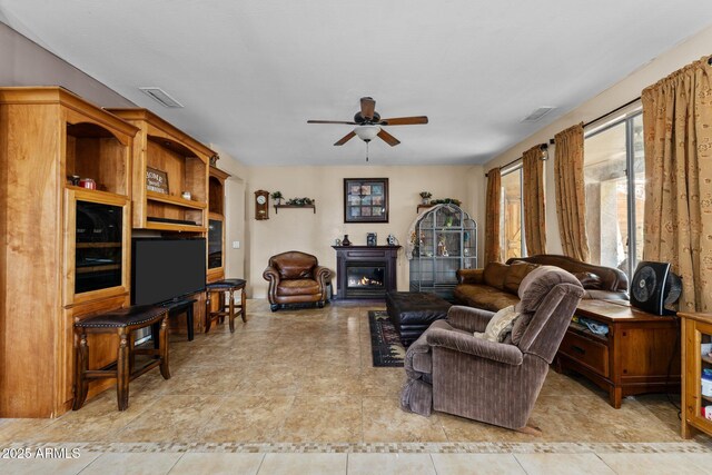 tiled living room featuring ceiling fan