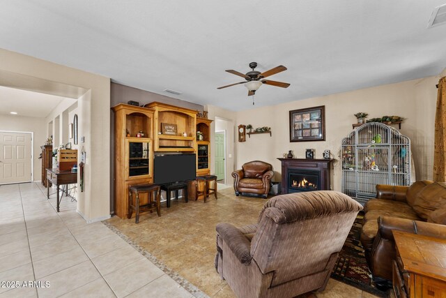 tiled living room featuring ceiling fan