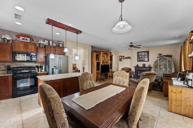 tiled dining area featuring ceiling fan