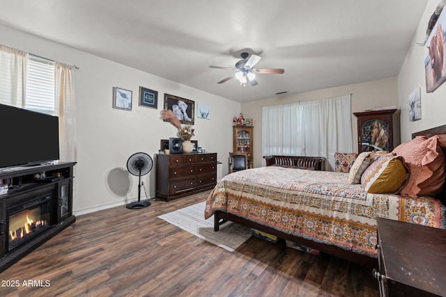 bedroom with dark hardwood / wood-style floors and ceiling fan