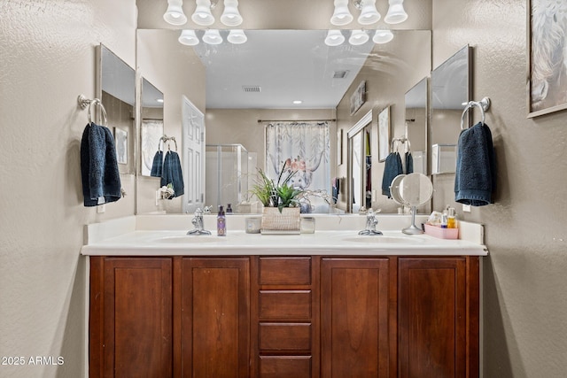 bathroom featuring vanity and a shower with door