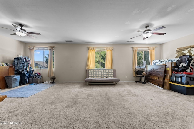 misc room featuring ceiling fan and carpet floors