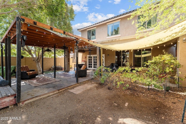 back of property with a patio area and french doors