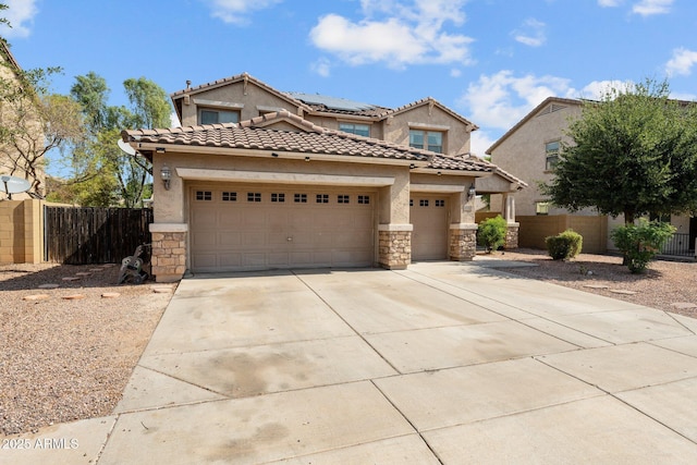 view of front of property with a garage and solar panels