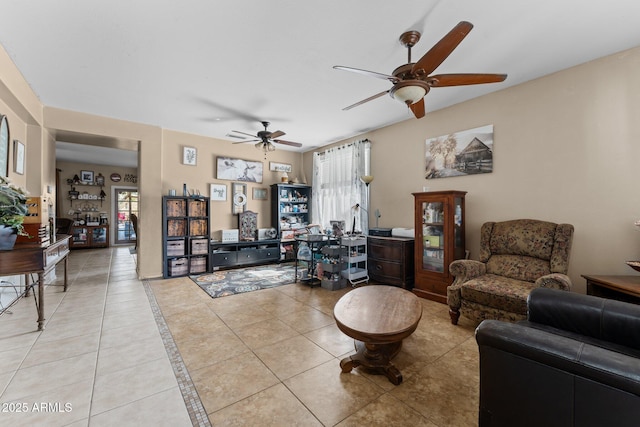 tiled living room with ceiling fan