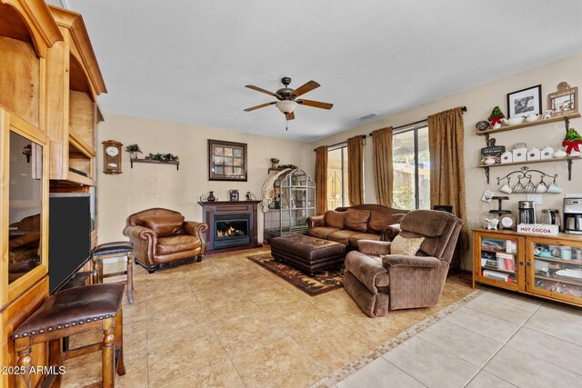 living room featuring light tile patterned flooring and ceiling fan