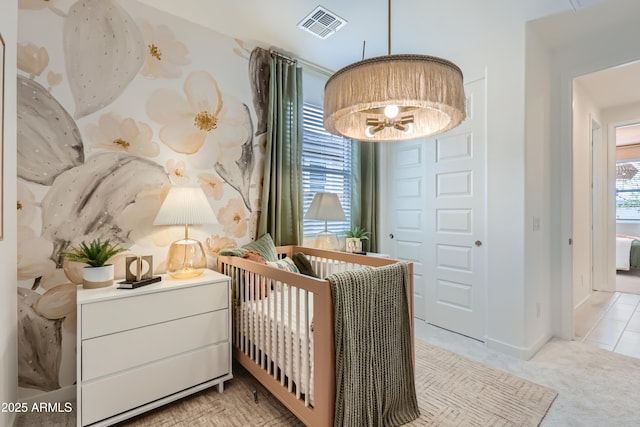 bedroom featuring visible vents, light carpet, baseboards, and an inviting chandelier
