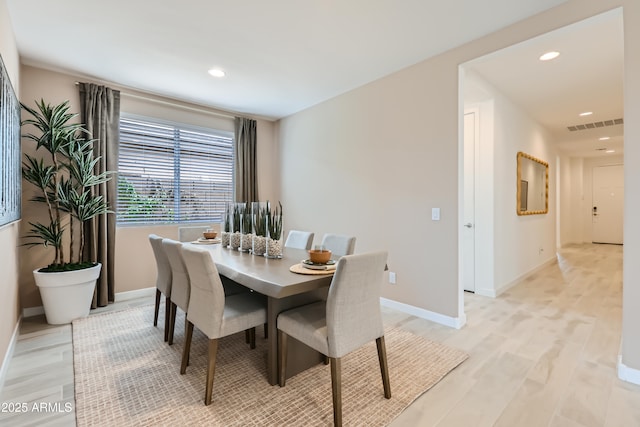 dining room featuring light wood-type flooring, baseboards, visible vents, and recessed lighting
