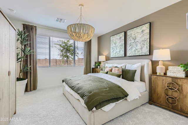 carpeted bedroom with an inviting chandelier and visible vents