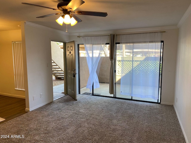 empty room featuring carpet flooring, ceiling fan, and crown molding