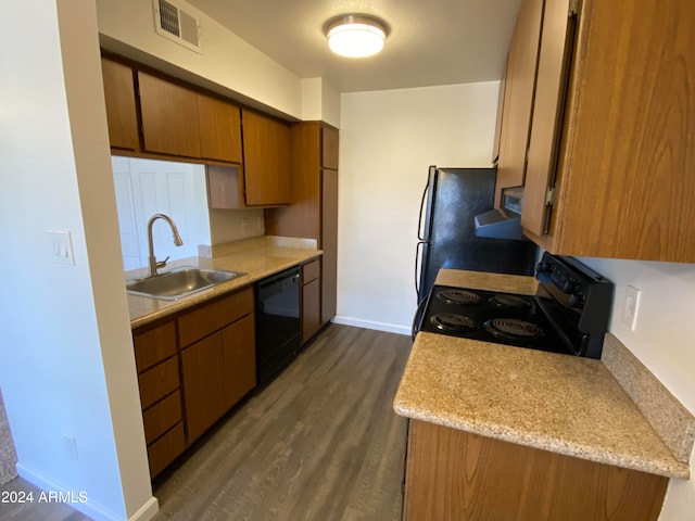 kitchen featuring black appliances, dark hardwood / wood-style flooring, sink, and range hood