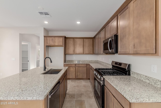 kitchen with visible vents, appliances with stainless steel finishes, light stone counters, a sink, and recessed lighting