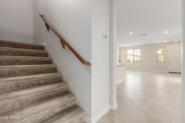 staircase with baseboards, tile patterned floors, and recessed lighting