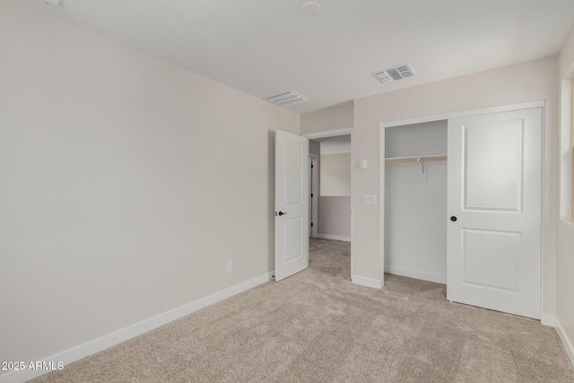 unfurnished bedroom featuring carpet, a closet, visible vents, and baseboards