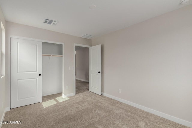 unfurnished bedroom featuring a closet, visible vents, baseboards, and carpet flooring