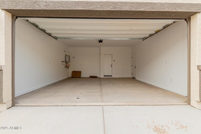 garage with a garage door opener and water heater