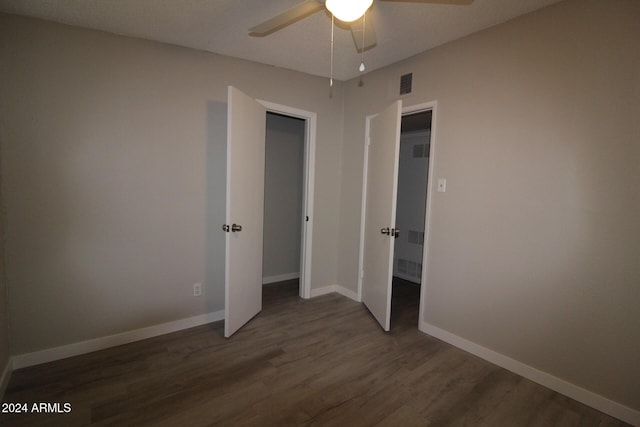 5918 S Grover Cyn Rd, Claypool, AZ 85532 - unfurnished bedroom with wood finished floors, baseboards, and a ceiling fan
