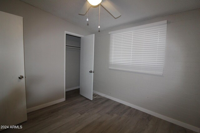 5918 S Grover Cyn Rd, Claypool, AZ 85532 - unfurnished bedroom with wood finished floors, baseboards, a closet, and ceiling fan