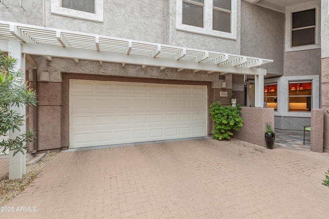 garage with decorative driveway